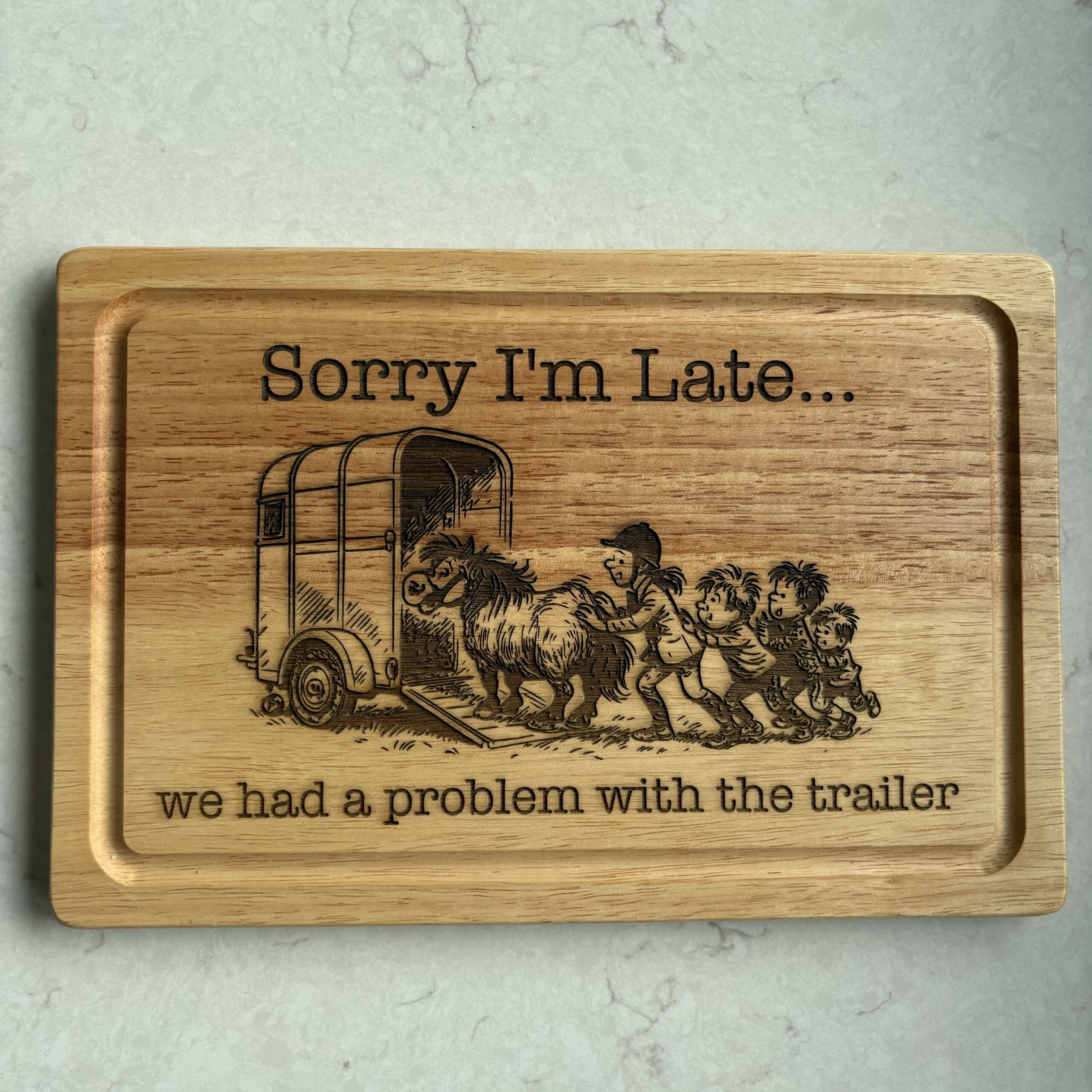 wooden cutting board with image of an equestrian scene